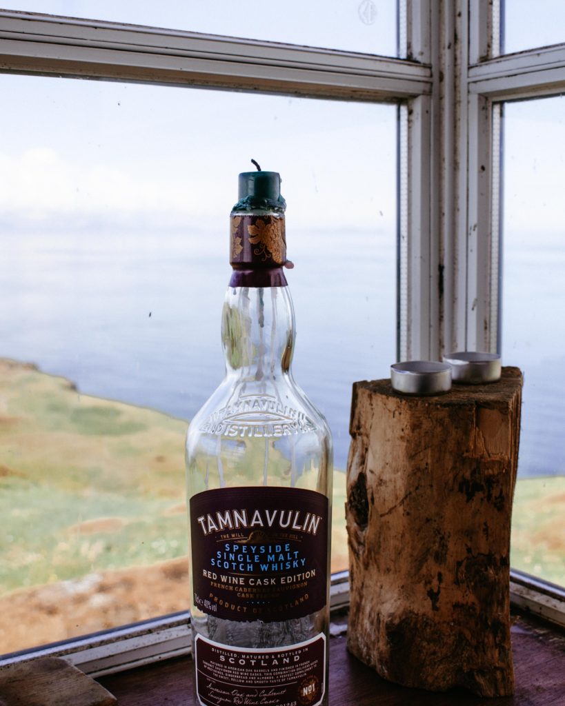 Bottle of whiskey used as a candle