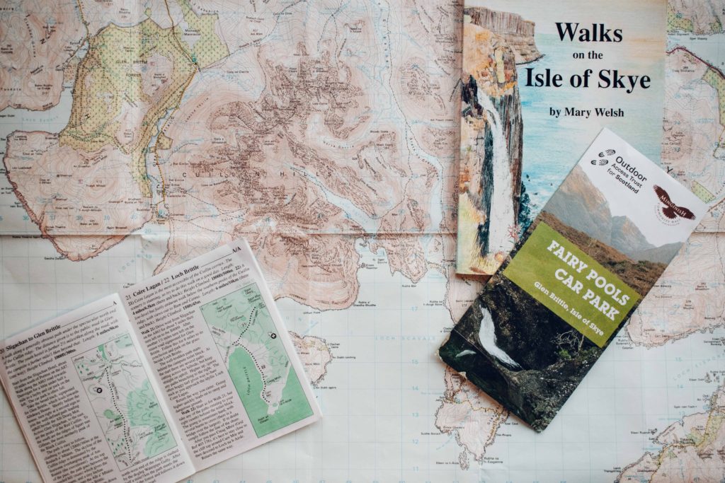 Map of Skye spread out with walking guides piked up on top of it