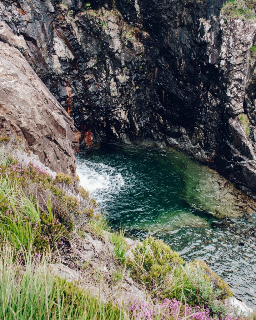 Blue green pool amongst dark rocks at Skye's Fairy Pools