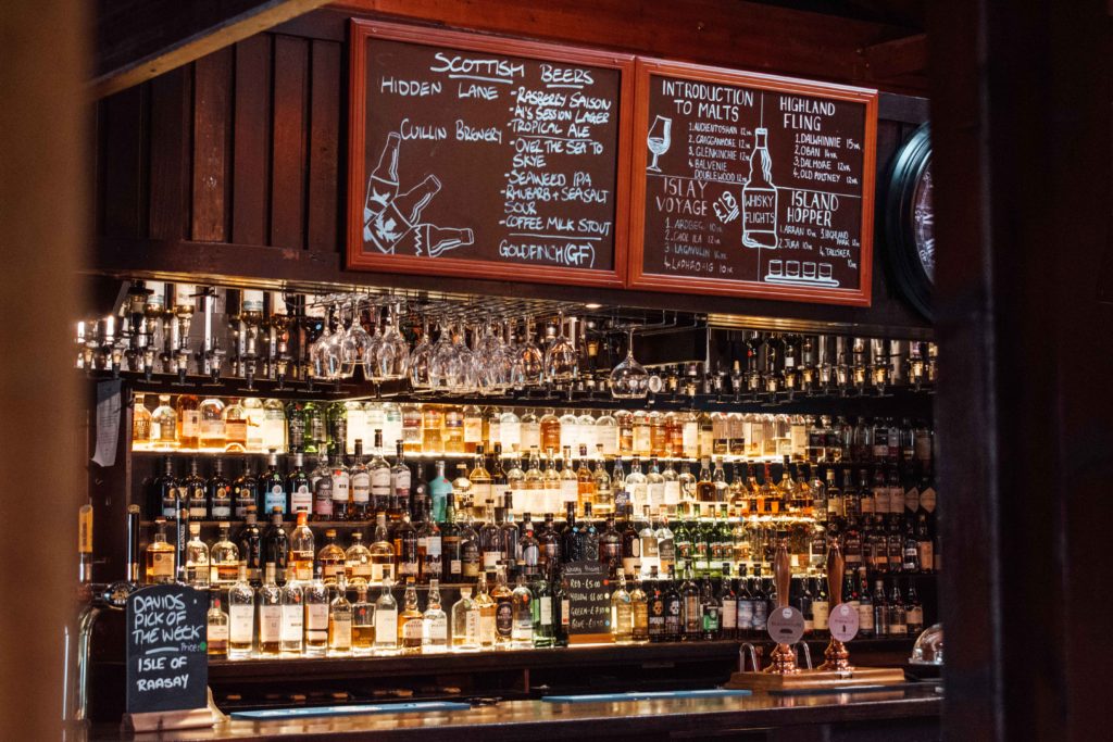 Huge array of whisky stacked behind the bar at the Sligachan hotel 