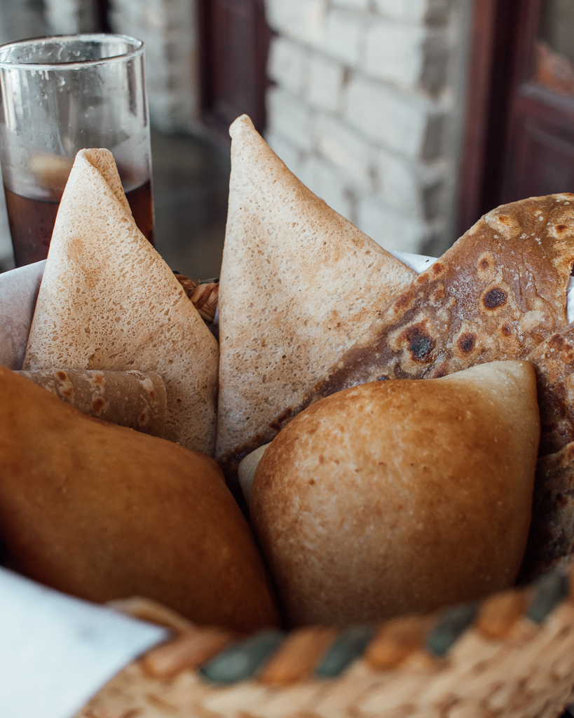 Selection of traditional Omani breads in a woven basket at Bait al Luban, Muscat