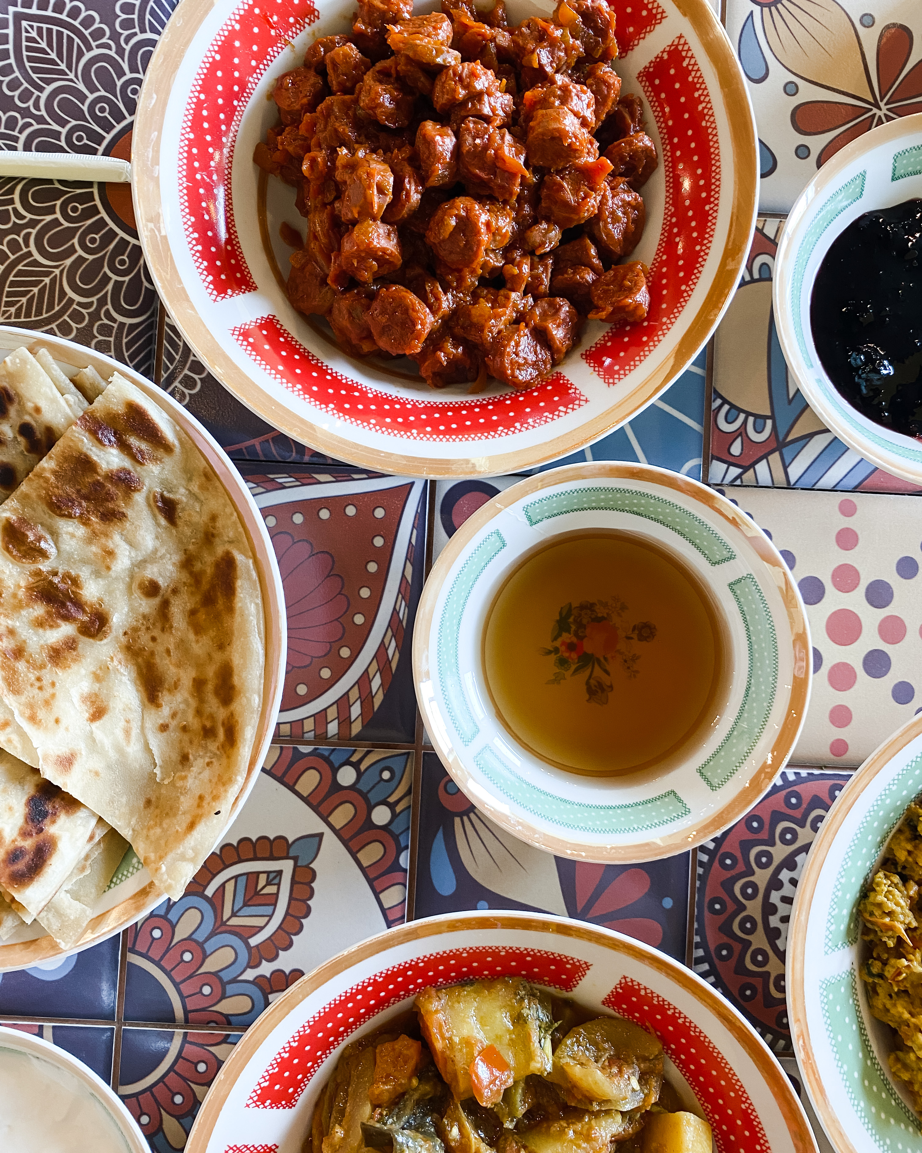 Where to Eat Muscat - Breakfast spread on a tile covered table at Mama Halima's