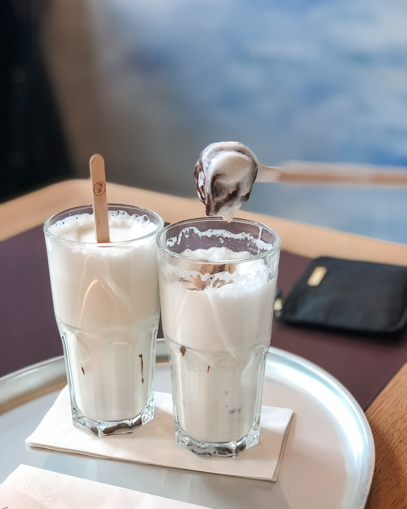 Stick of chocolate melted into two glasses of milk - where to eat in Lucerne