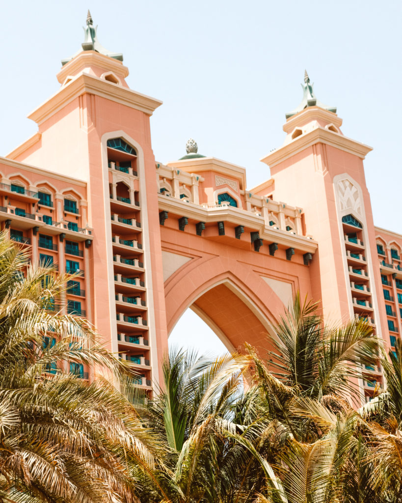 Palm trees in front of the pink facade of The Atlantis Hotel, Dubai