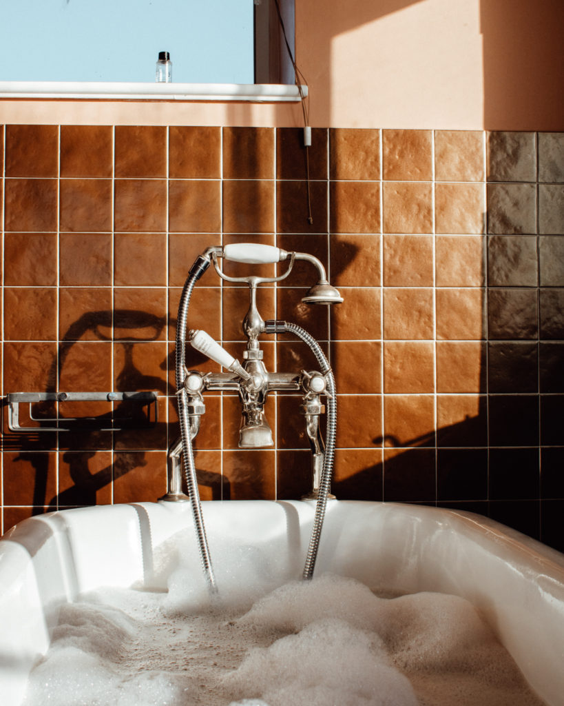 Bubble bath in a vintage inspired bedroom at Burgh Island Hotel