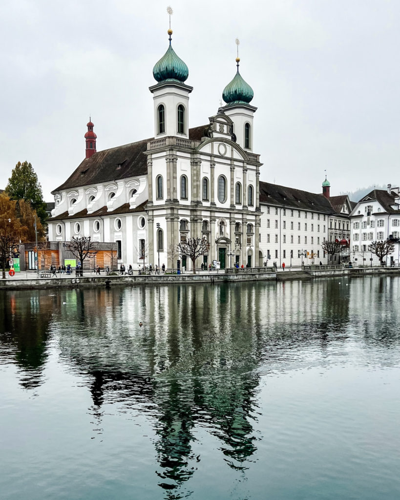 Wintery grey view over river to Lucerne Jesuit Church