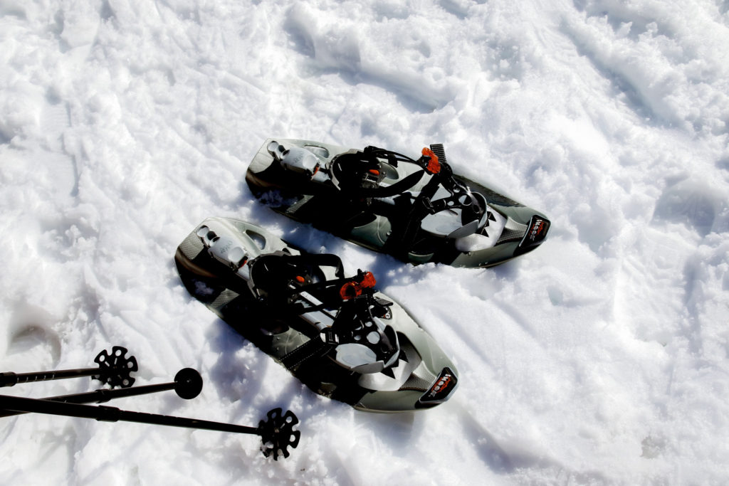 Pair of snowshoes and poles on the snow