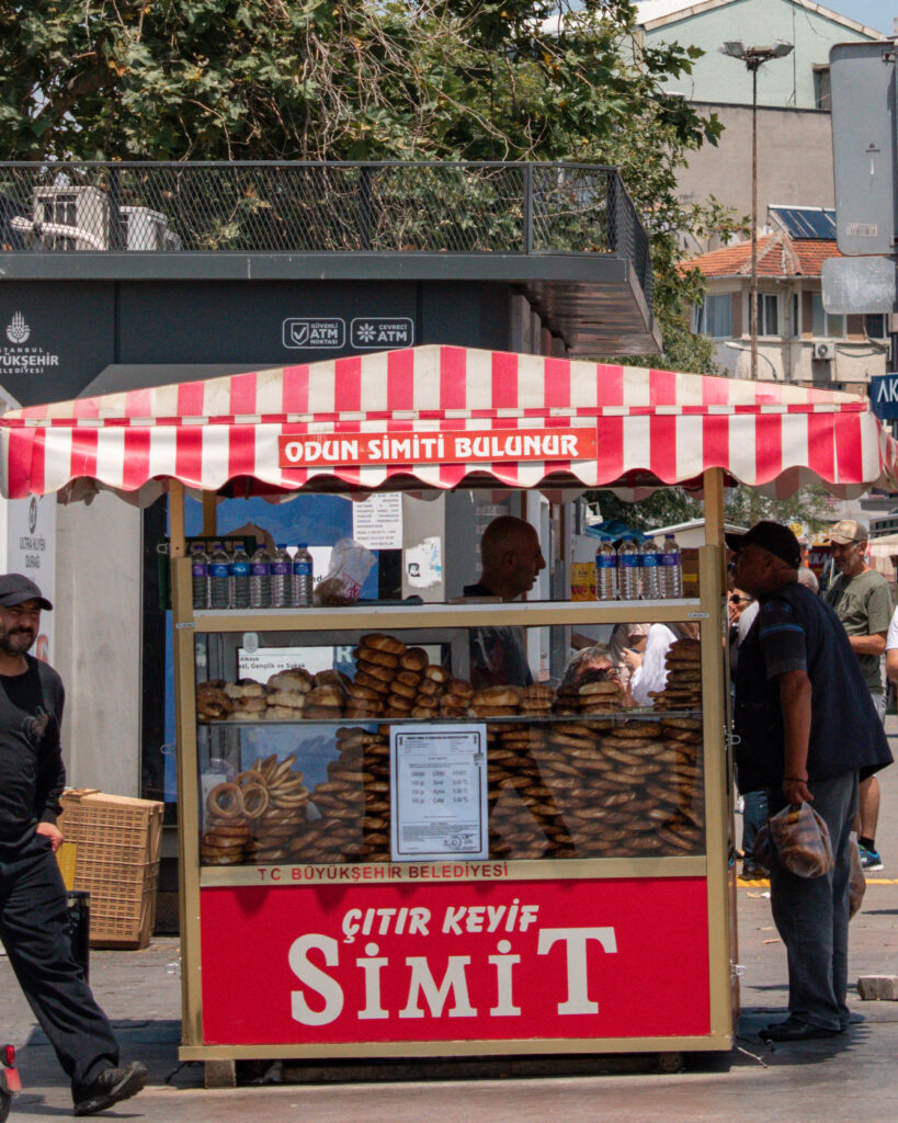 Red and white striped street food stall selling Simit, traditional Turkish bread