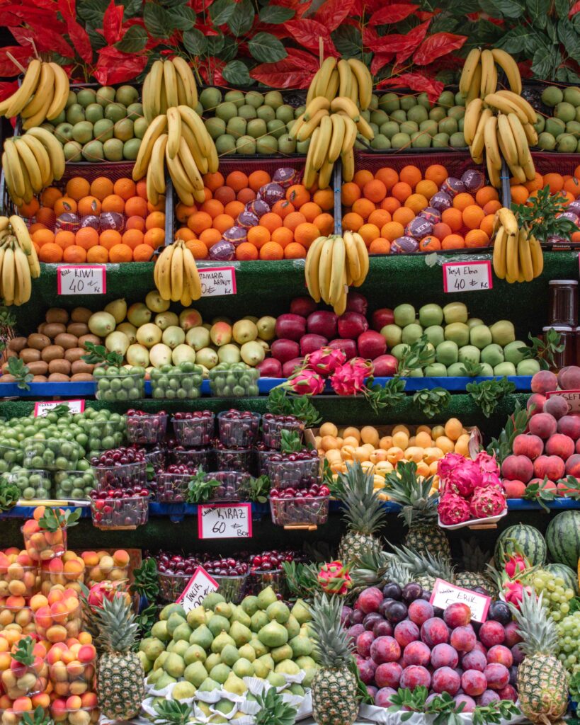 Brightly coloured fruits filling multiple shelves in an outdoor market in Istanbul