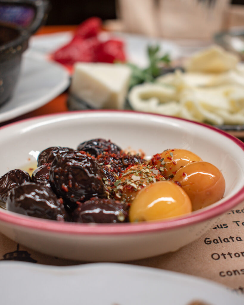 Small bowl of green and black olives