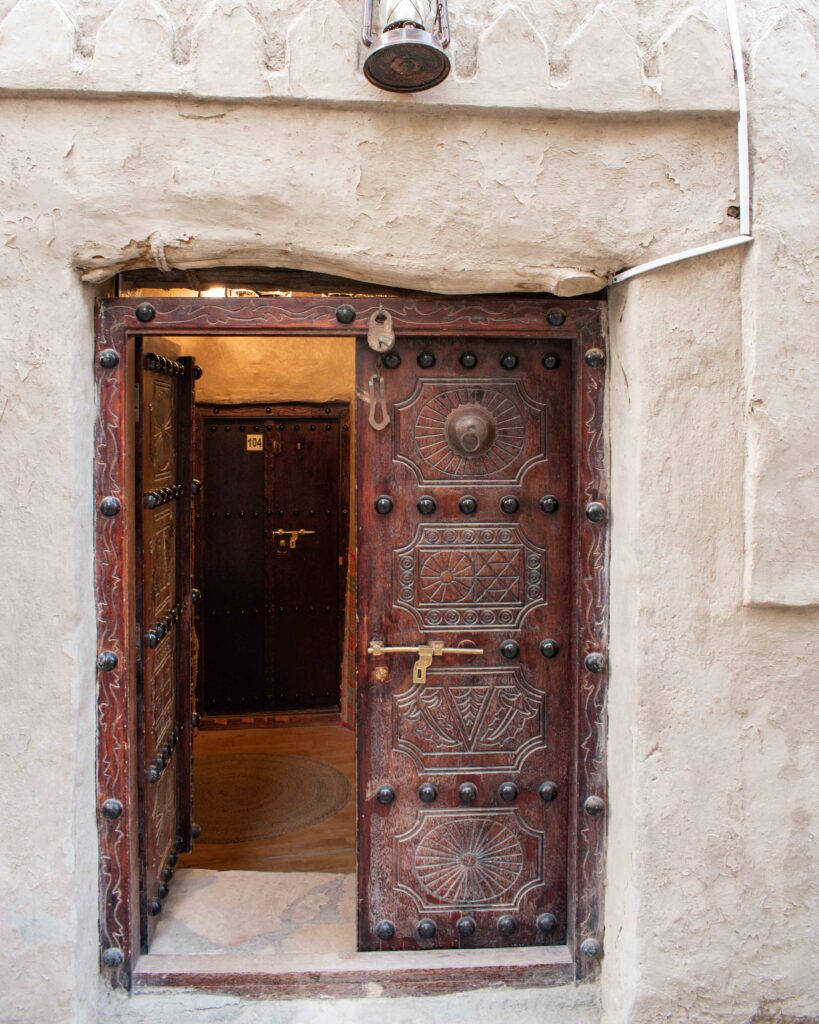 Intricately carved Omani wooden door at Nizwa Antique Inn