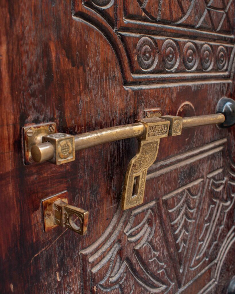 Close up of brass carved lock on wooden Omani door