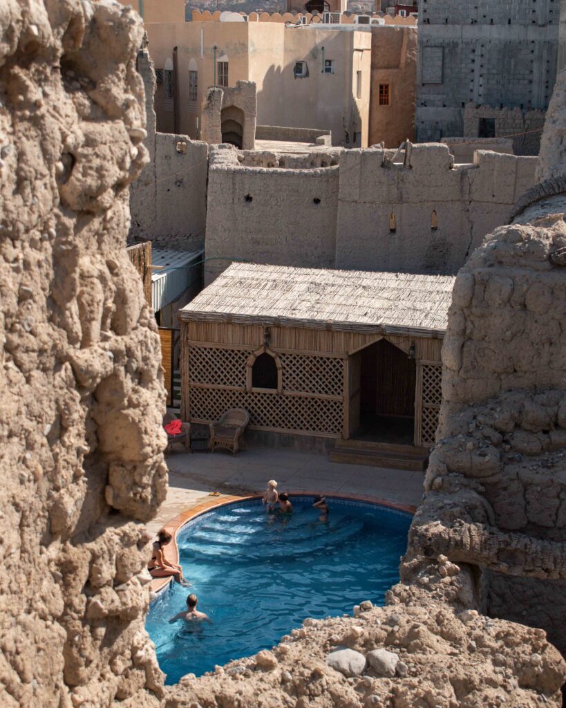 Swimming pool glimpsed through rubble stone walls