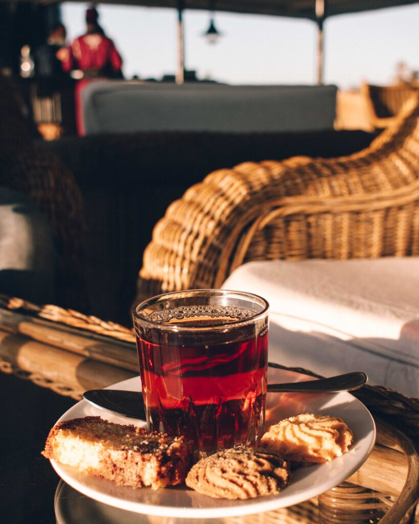 Glass of Egyptian tea on a saucer with biscuits on the sun deck of the SS Sudan, glowing in the afternoon sunshine