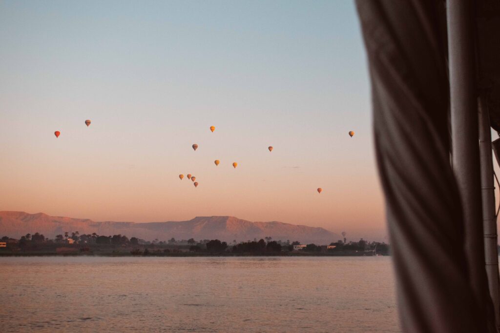 Hot air balloons floating over the banks of the River Nile at Luxorat sunrise