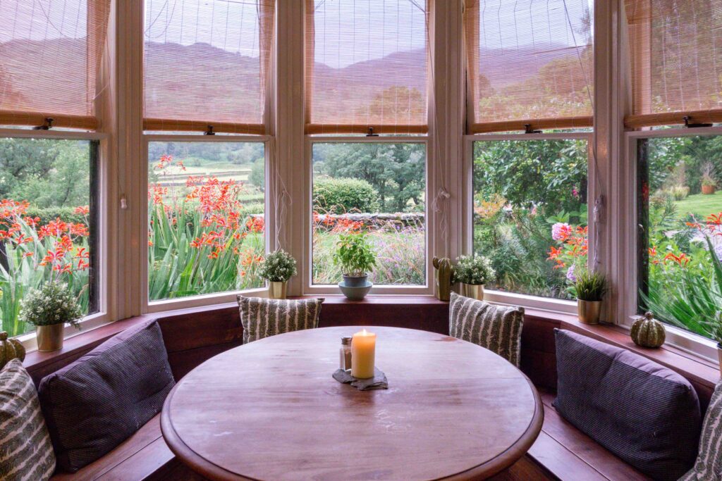 Booth seat in large bay window looking onto green fells around Grasmere