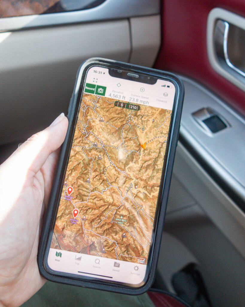 Close up of a mobile phone displayingGPS coordinates and a route map on the Gaia off road navigation app