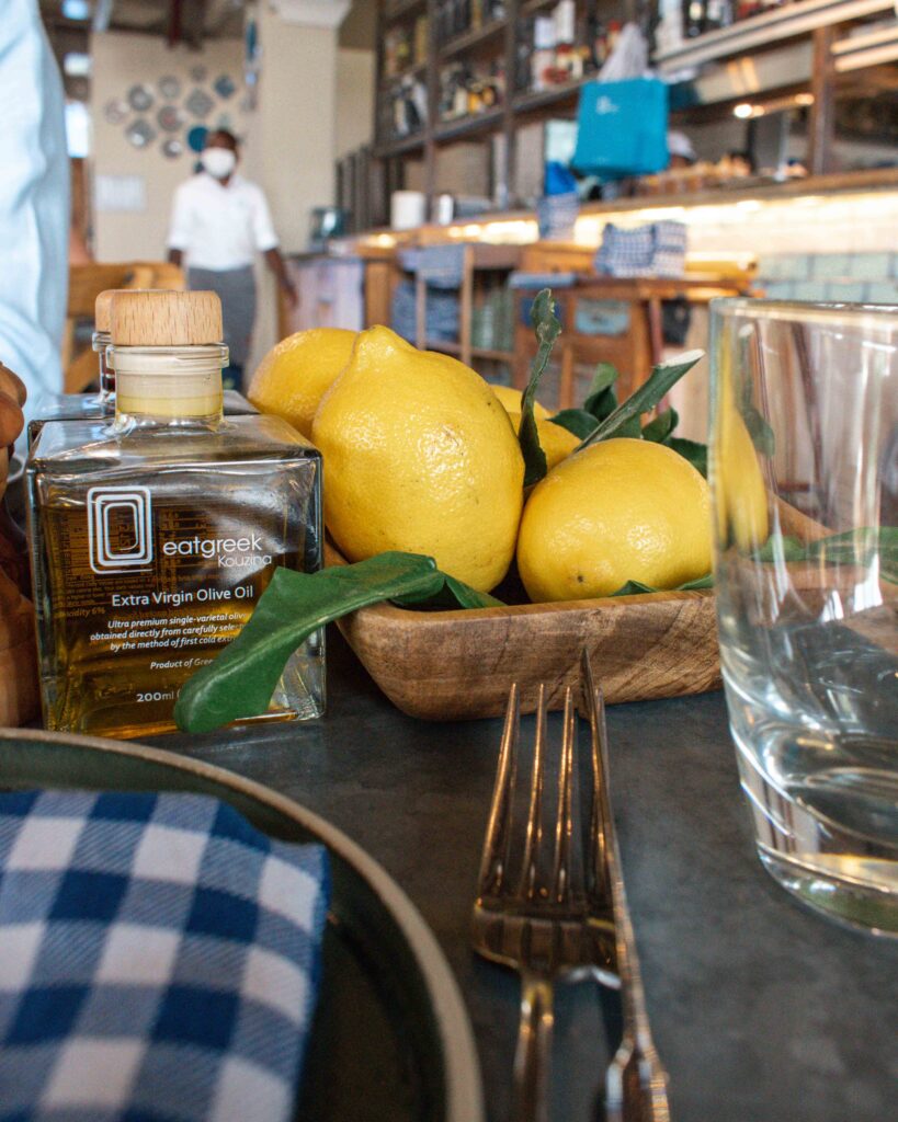 Bowl of lemons next to bottle of olive oil at Eat Greek Kouzina, Dubai