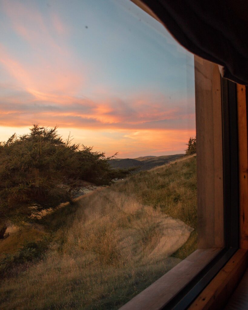Pink sunset skies over Lake District from inside Hinterlandes Hidden Hut