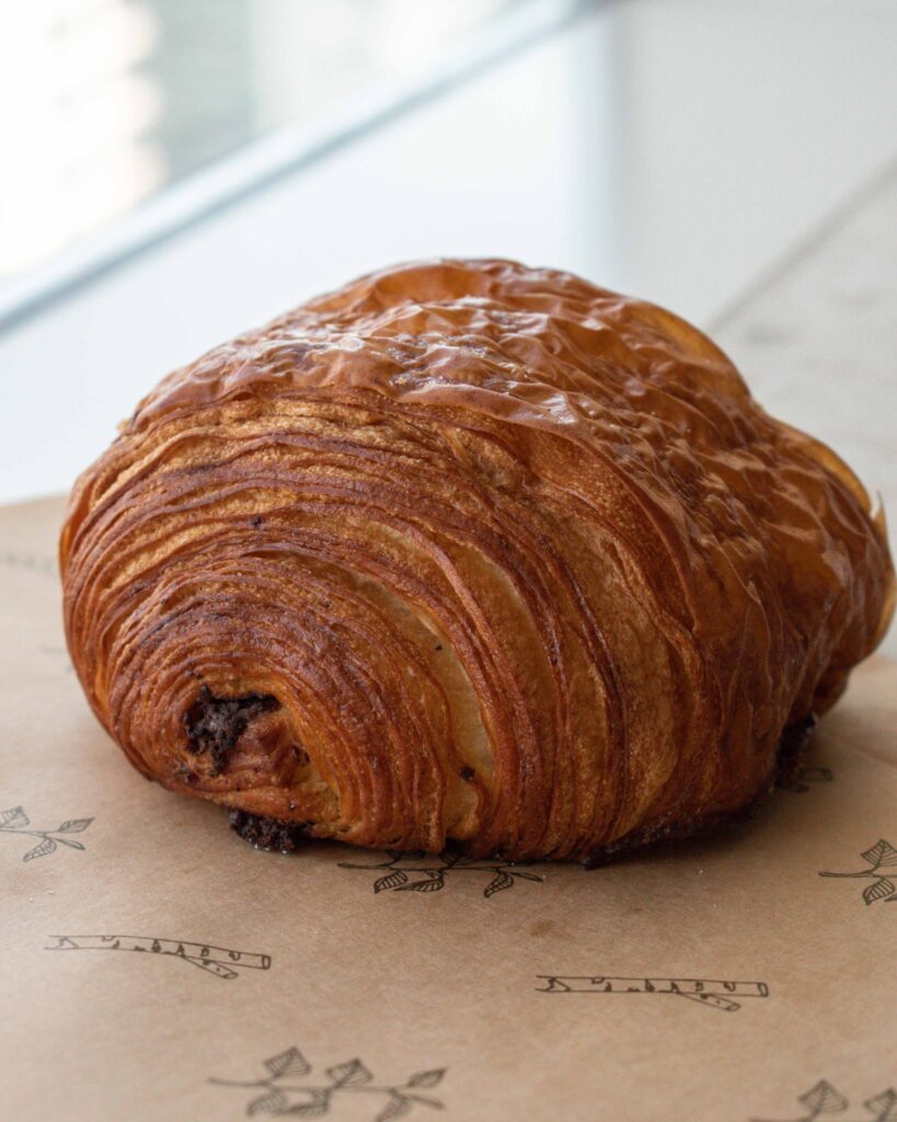 Close up of flaky pain au chocolat from Birch Bakery, Dubai 
