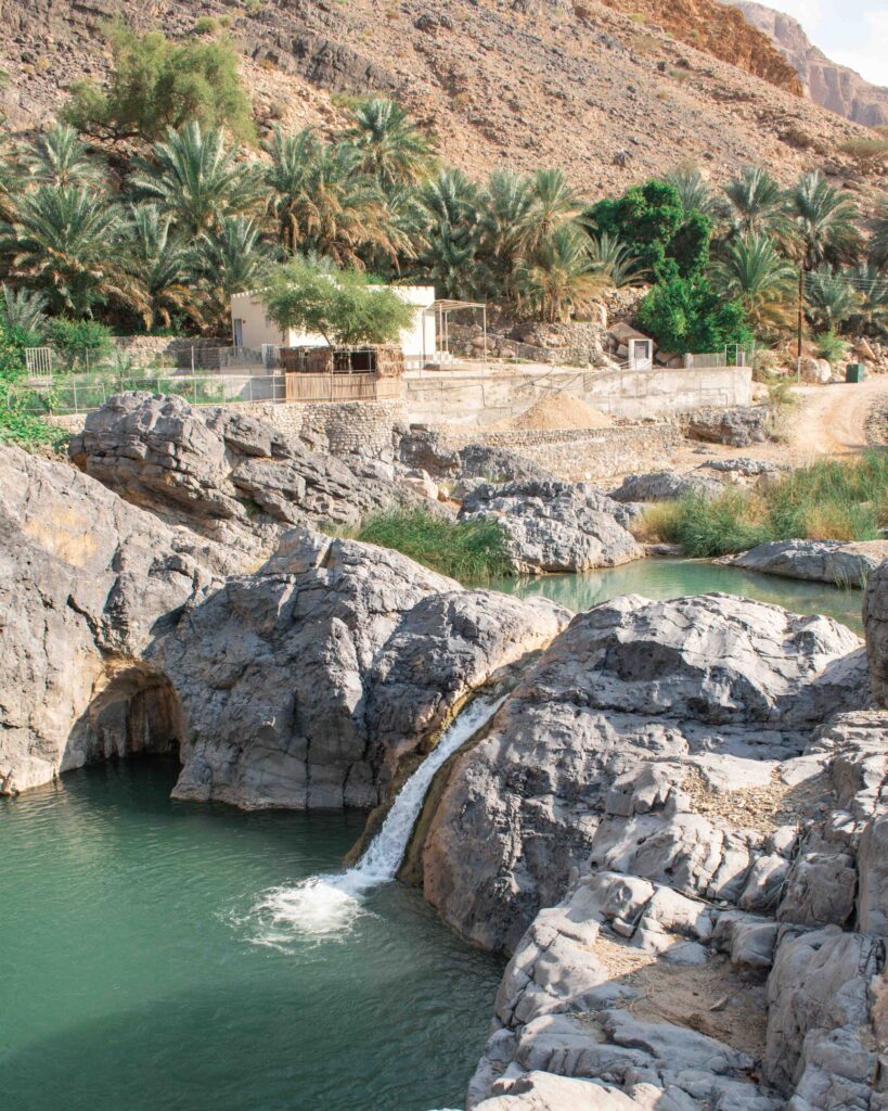 Green pool with waterfall in Oman's Wadi Al Abraeen