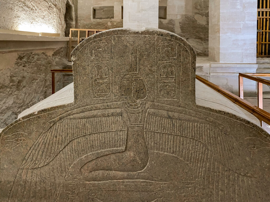 Grey stone sarcophagus of Merenebetah, etched with a winged figure and cartouche