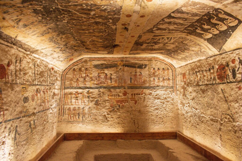 Rough hewn stone walls of a chamber, painted with funerary text in the tomb of Rameses IX