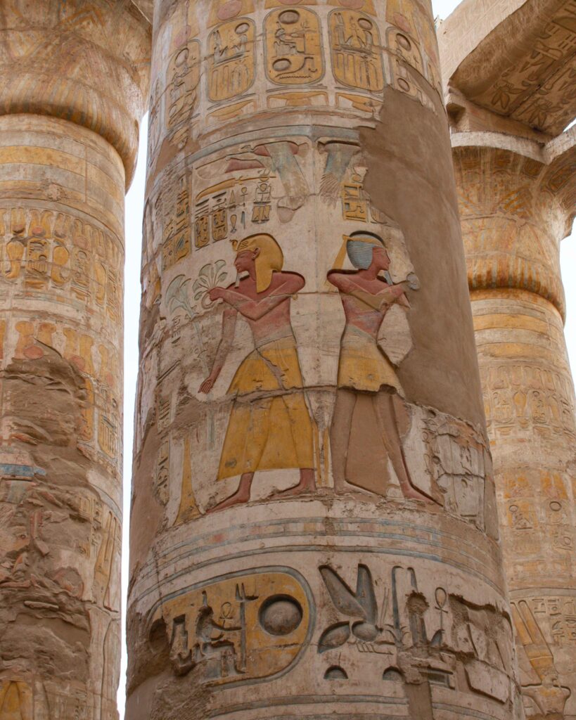 Close up of the vibrant painted columns of the Great Hypostyle Hall, Karnak Temple, Egypt