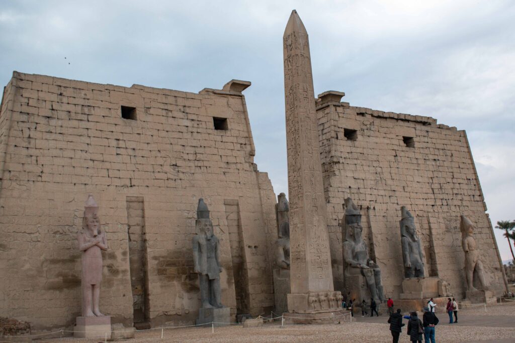 Obelisk and Pharoah statues in front of Luxor Temple, Egypt, on a grey day
