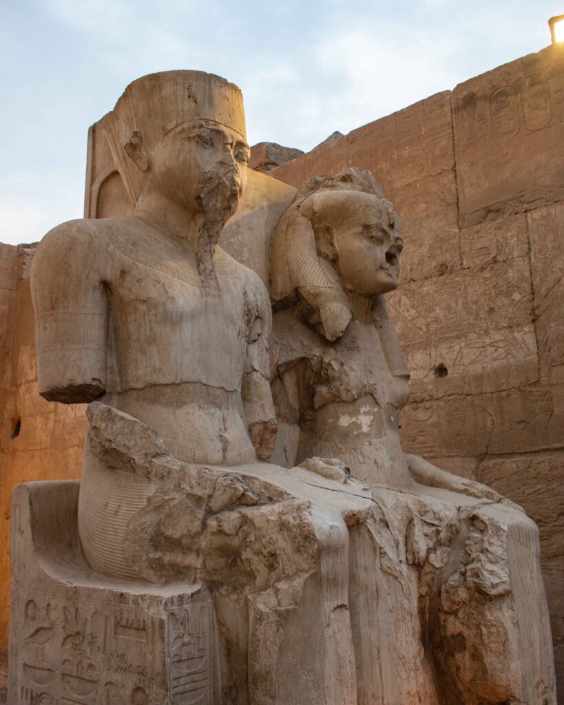 Large damaged statue of seated Tutankhamun and his wife at Luxor Temple, Egypt