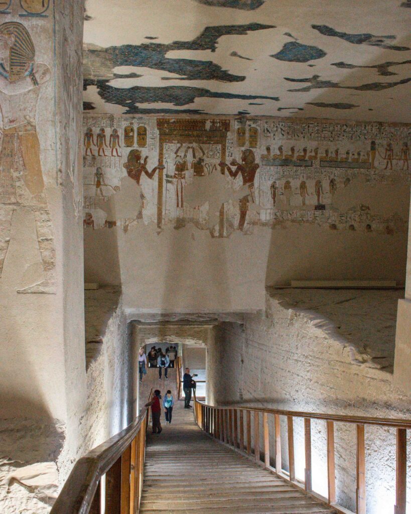 Wooden walkway leading into stone passage painted with figures in the tomb of Merenebetah 