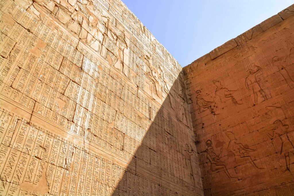 Sunlight hitting the incredibly detailed cartouche carvings on the wall of Edfu Temple, Egypt 