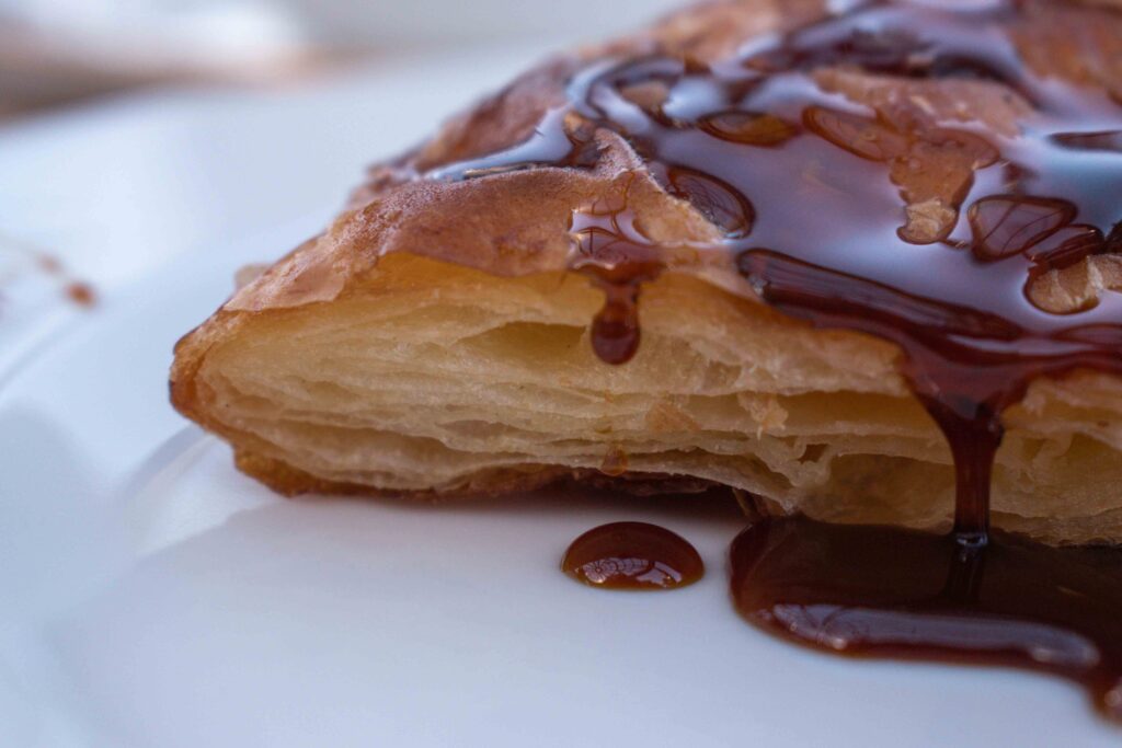 Close up of Egyptian feteer covered in dark molasses