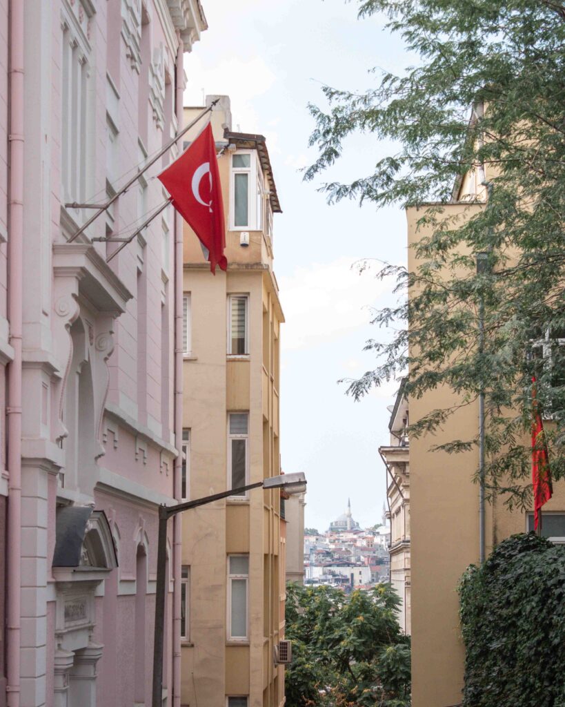 Turkish flag hanging from a pink building