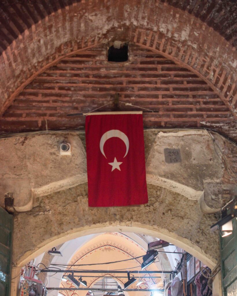 Turkish flag hanging from the brick ceiling of Grand Bazaar 
